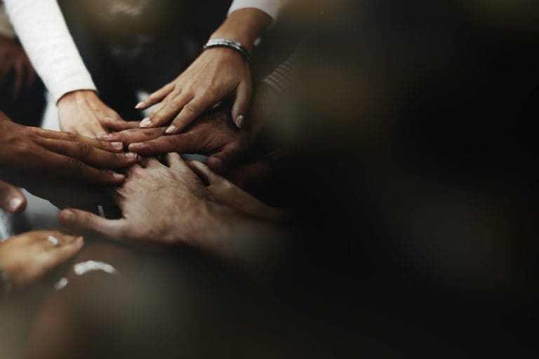 Business people stacking their hands