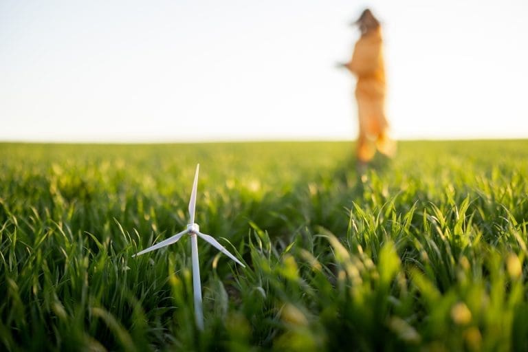 Toy wind generator on green field