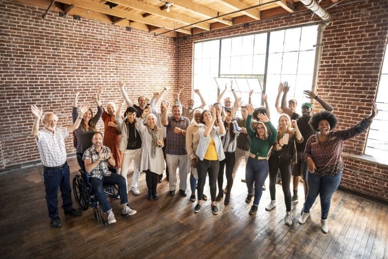 group-of-diverse-people-standing-in-front-of-a-bri-2023-11-27-05-25-54-utc